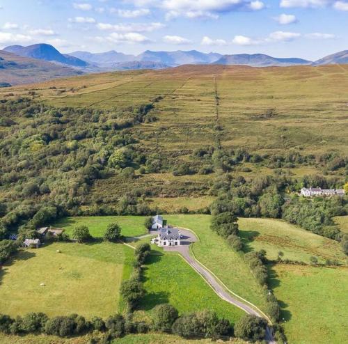 an aerial view of a house on a road in a field at Luxury Country House on the Hill in Kenmare
