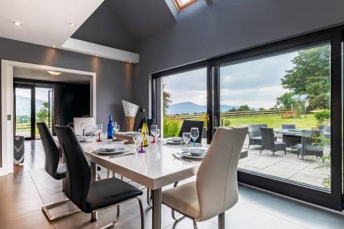 a dining room with a table and chairs at Luxury Country House on the Hill in Kenmare