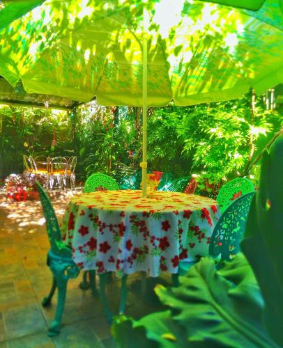 a table and chairs under an umbrella on a patio at Hotel Oasis in San Salvador