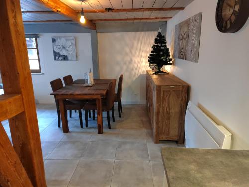 a dining room with a table and a christmas tree on it at Petite maison alsacienne in Entzheim