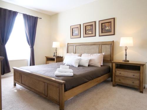 a bedroom with a bed with two towels on it at 3Br 2Bath Condo Balcony 5min Conv Center 1410ft in Orlando