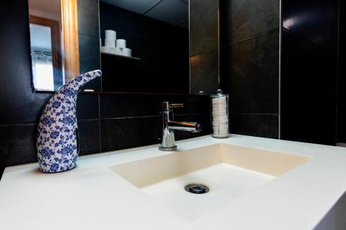 a bathroom sink with a vase on top of it at Dreams Almería Center in Almería