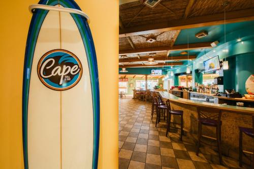 a surfboard in a restaurant with a bar at Holiday Inn Club Vacations Cape Canaveral Beach Resort in Cape Canaveral
