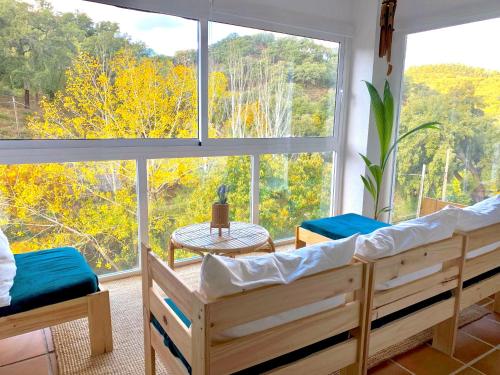 a bedroom with two beds and a large window at Casa Rural Una Ventana a la Montaña in Aracena