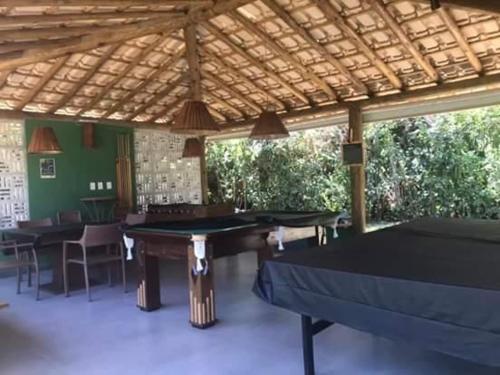 a room with ping pong tables in a pavilion at Vilage Itacimirim - Condominio Quinta das Lagoas Residence in Itacimirim
