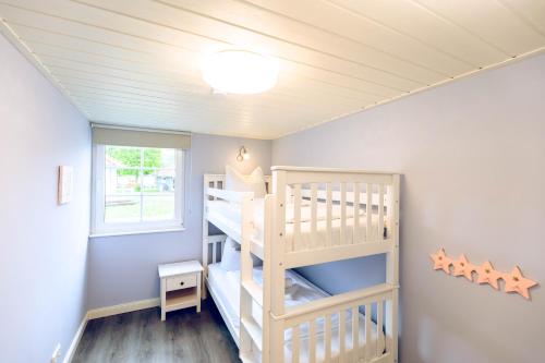 a childs room with a wooden bunk bed at Regenbogen Boltenhagen in Boltenhagen