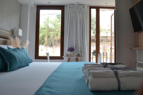 a bedroom with a large bed and a large window at Katari Apart Hotel at Qorikancha in Cusco