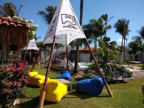 a playground with inflatable balls and a flag at Pousada ON VIBE Cumbuco in Cumbuco