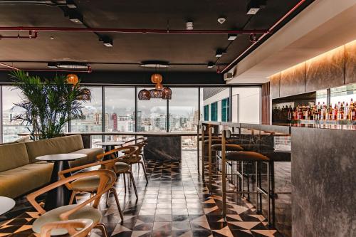 a bar with a view of a city at Pullman Lima Miraflores in Lima