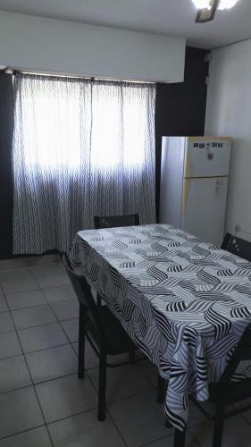 a kitchen with a table with a black and white table cloth at Casa Necochea in Necochea