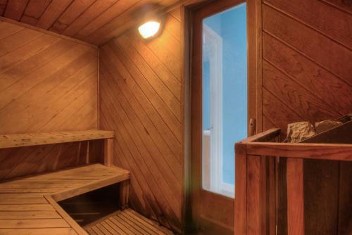an empty wooden sauna with a window in it at Sea Gypsy Rentals in Lincoln City