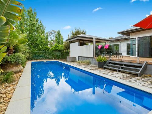 a swimming pool in the backyard of a house at Kamala Mount Eliza in Mount Eliza