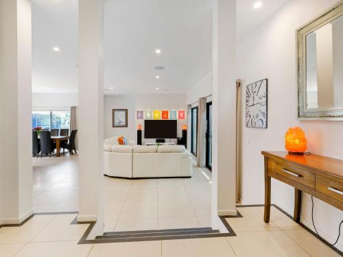 a living room with a white couch and a television at Kamala Mount Eliza in Mount Eliza