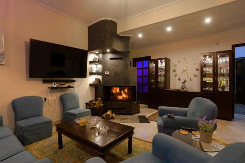 a living room with a couch and a fireplace at Efis guest house near Nafpaktos-Fully Equipped Home in Nafpaktos