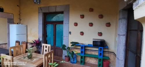 a kitchen with a table and chairs and a refrigerator at Lavanda Centro Histórico de Querétaro in Querétaro