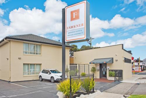 a sign for a laundromat in front of a building at Fawkner Executive Suites & Serviced Apartments in Melbourne