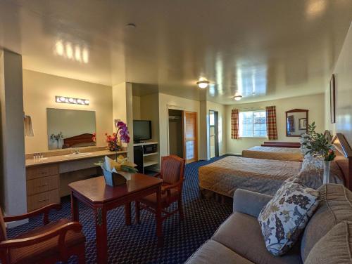a hotel room with a bed and a bathroom at Americas Best Value Inn Oxnard-Port Hueneme in Port Hueneme