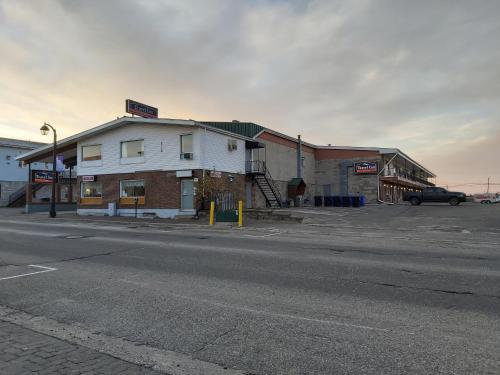 an empty parking lot in front of a building at Travel Inn Hearst in Hearst