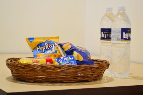 a basket of chips and snacks next to two bottles of water at Citadel Resort in Panchgani