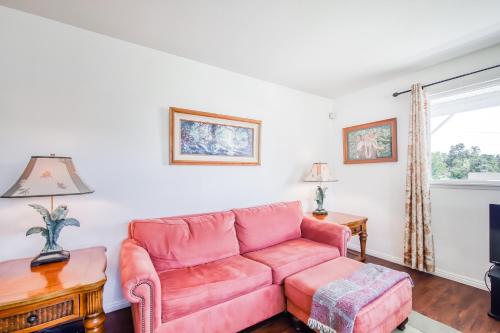 a living room with a pink couch and a table at Volcano Cottage in Volcano