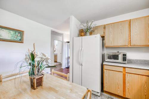 a kitchen with a white refrigerator and wooden cabinets at Volcano Cottage in Volcano