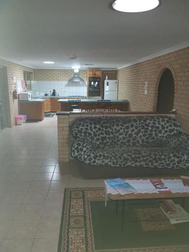 a living room with a couch and a table at Rhodeside Lodge in Geraldton