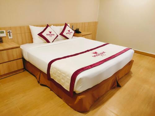 a bed with two pillows on it in a room at VISUHA HOTEL in Ha Tien