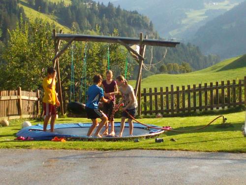 a group of children playing on a playground at Schaidreithof in Grossarl