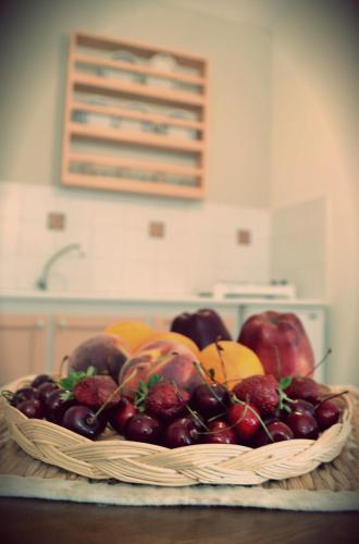 a basket of fruit on a table in a kitchen at Anemologio in Finikas