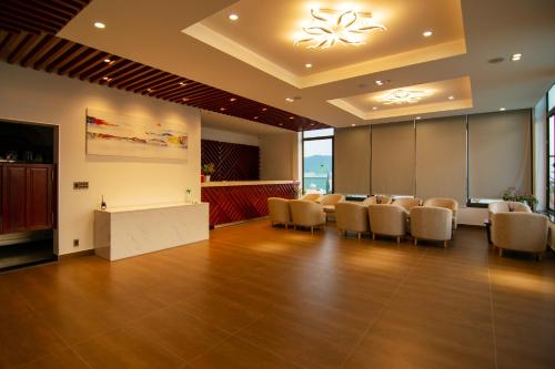 a conference room with chairs and a table and a podium at VISUHA HOTEL in Ha Tien