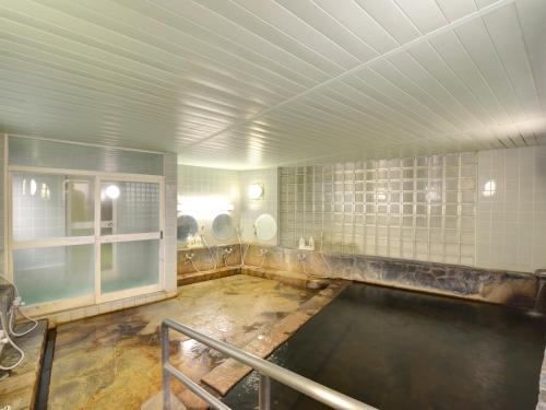 an empty bathroom with a pool of water at Hotel Parkway in Teshikaga