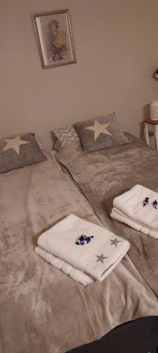a bed with two towels and stars on it at Polaris Homes Huippu in Syöte