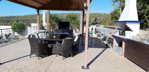 a patio with a table and chairs and a grill at Nayia Paradise Villa! Best Villa in Cyprus in Paphos City