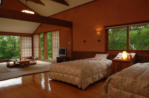 מיטה או מיטות בחדר ב-Resonate Club Kuju