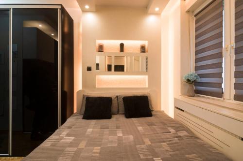 a bedroom with a bed with two pillows at Arizona in Novi Sad