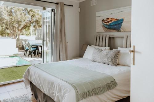 a bedroom with a bed and a view of a patio at Joyful in Paternoster