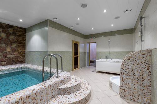a large bathroom with a tub and a bath tub at Zahar Berkut in Slavske