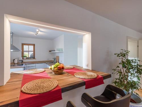 a dining room table with a bowl of fruit on it at Ferienwohnung Bergahorn in Oberaudorf