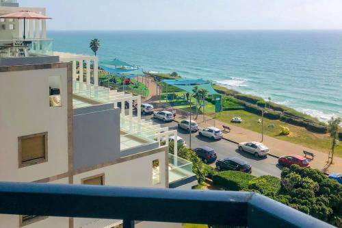 a view of a parking lot next to the ocean at Royal Aparatment on the Sea , Blvd Nitza 34 in Netanya