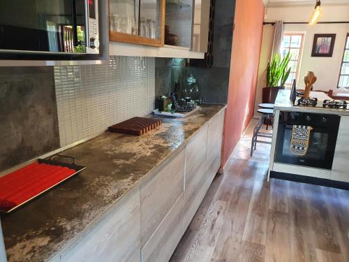 a kitchen with a counter top in a room at Hacienda Holiday Home in Richards Bay