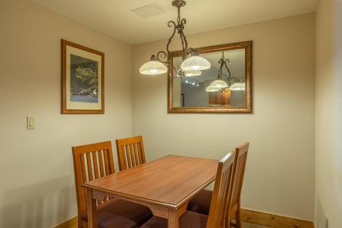 a dining room table with chairs and a mirror at Grand Lodge 1-Bedroom Condo with 3 Queens & Close to Everything condo in Crested Butte