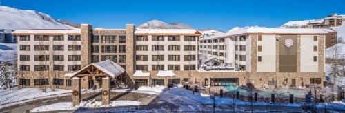 a hotel in the mountains with snow on the ground at Grand Lodge 1-Bedroom Condo with 3 Queens & Close to Everything condo in Crested Butte