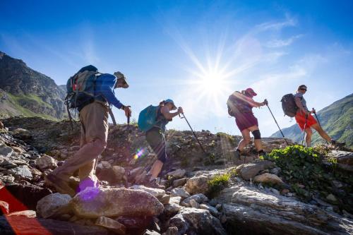 a group of people hiking on a rocky mountain at Résidence Club MMV Samoens in Samoëns