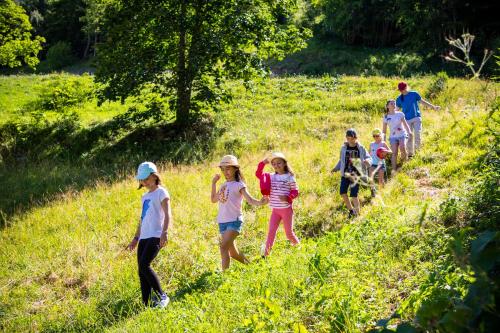 a group of children walking in a field at Résidence Club MMV Samoens in Samoëns