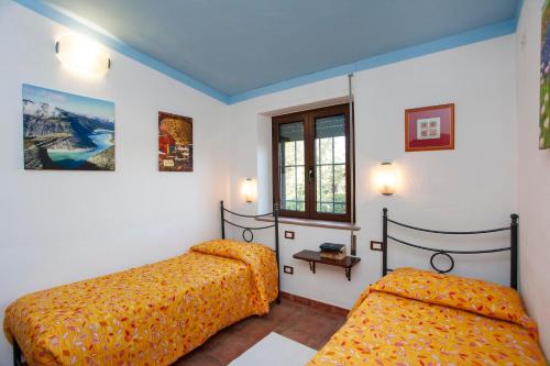 Ένα ή περισσότερα κρεβάτια σε δωμάτιο στο Tipica Casa di Campagna - Orosei