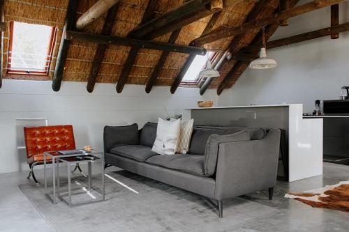 a living room with a couch and a table at Das Loft in Paternoster