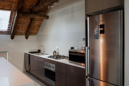a kitchen with a stainless steel refrigerator at Das Loft in Paternoster