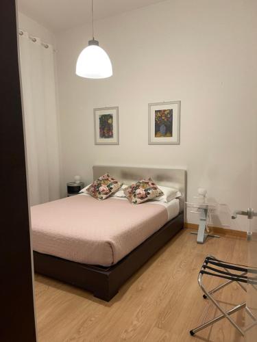 a bedroom with a bed with two pillows on it at PALAZZO MARCHETTI in Ancona