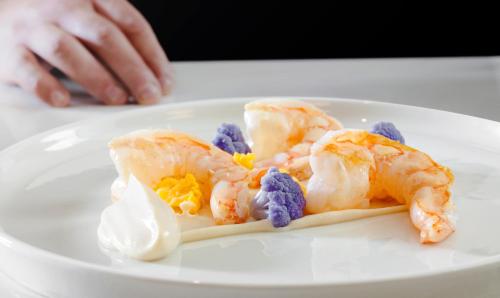 a plate of food with shrimp on a table at No 15 Ermou Hotel in Thessaloniki