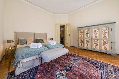 a bedroom with a large bed and a rug at BED and BIKE - BERGAMO Dream House in Bergamo